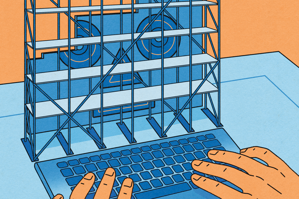 Hands typing on laptop with a building scaffold shaped like a face on the screen.