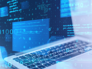 Laptop screen displaying software code and digital binary data overlays, representing programming.