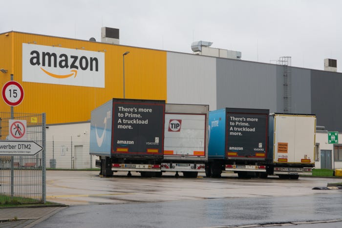 Amazon warehouse and delivery trucks