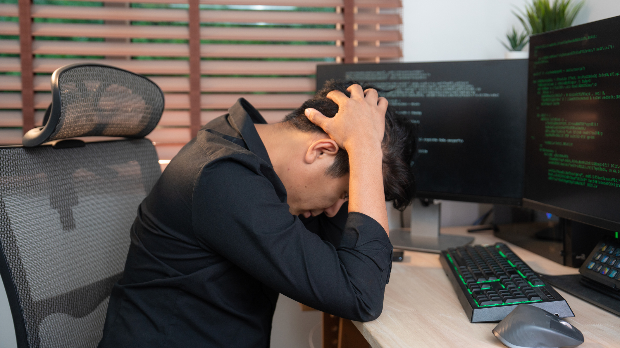 A developer looking stressed while working on code