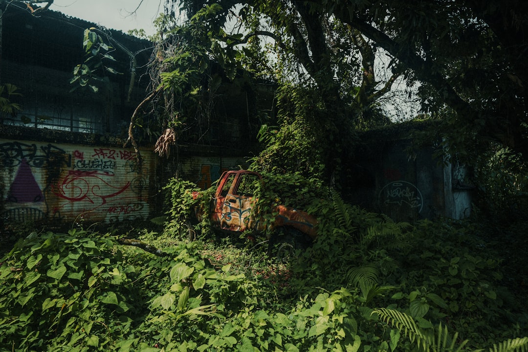 Large pile of green plants next to a modern building symbolizing growth in technology fields
