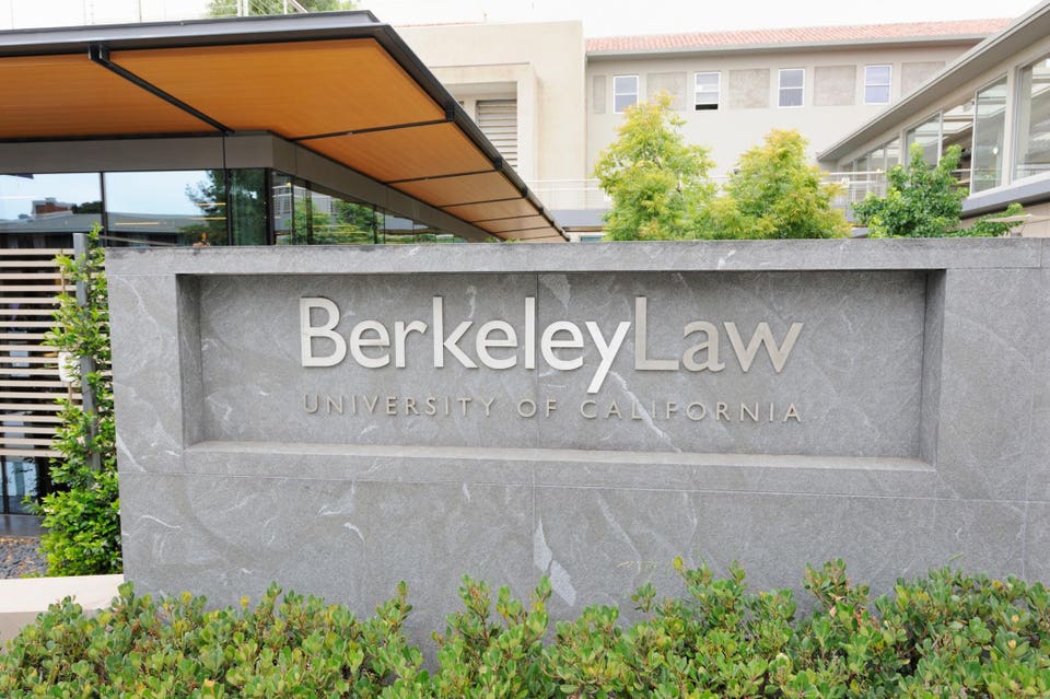 UC Berkeley School of Law building with autumn foliage in foreground